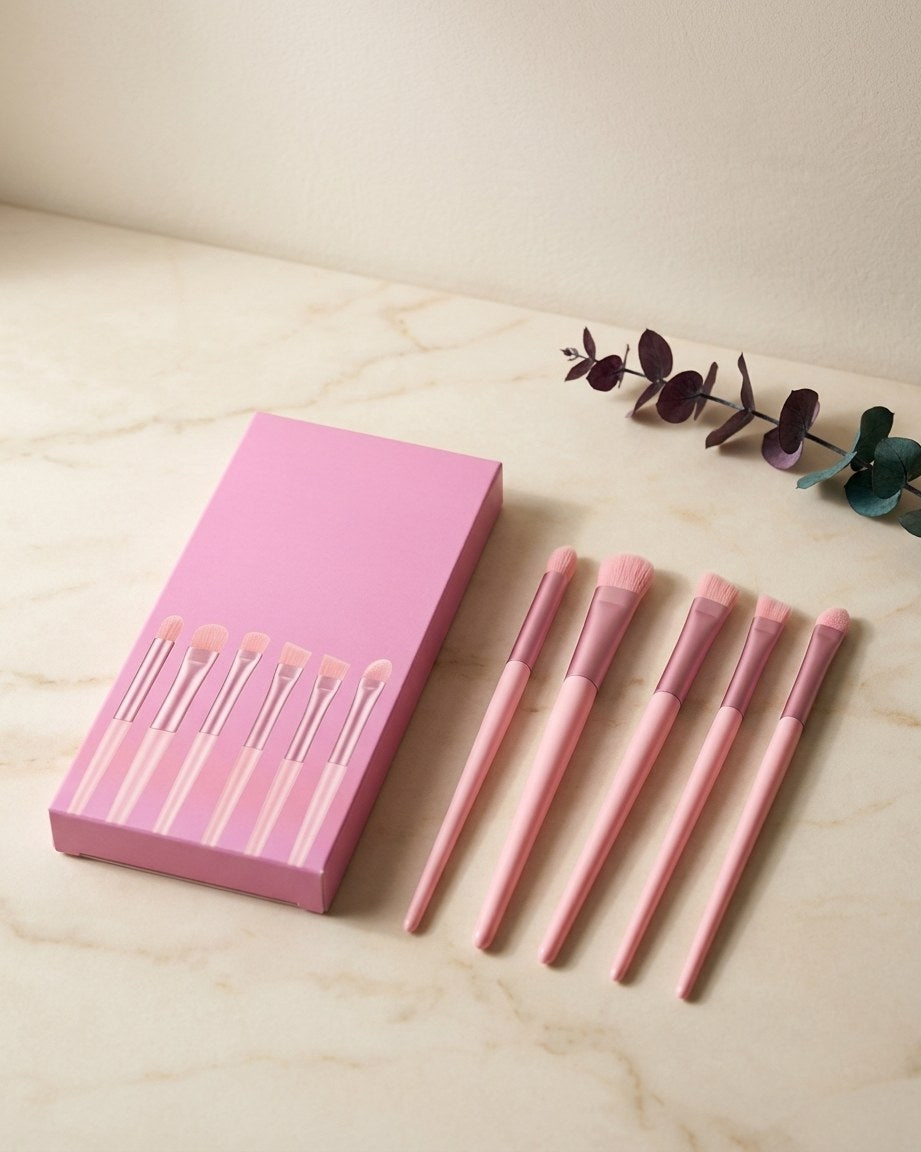 Six-piece makeup brush set on a cream linen table